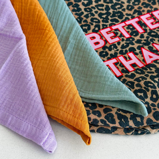 Stack of colorful fabric organic cotton muslins