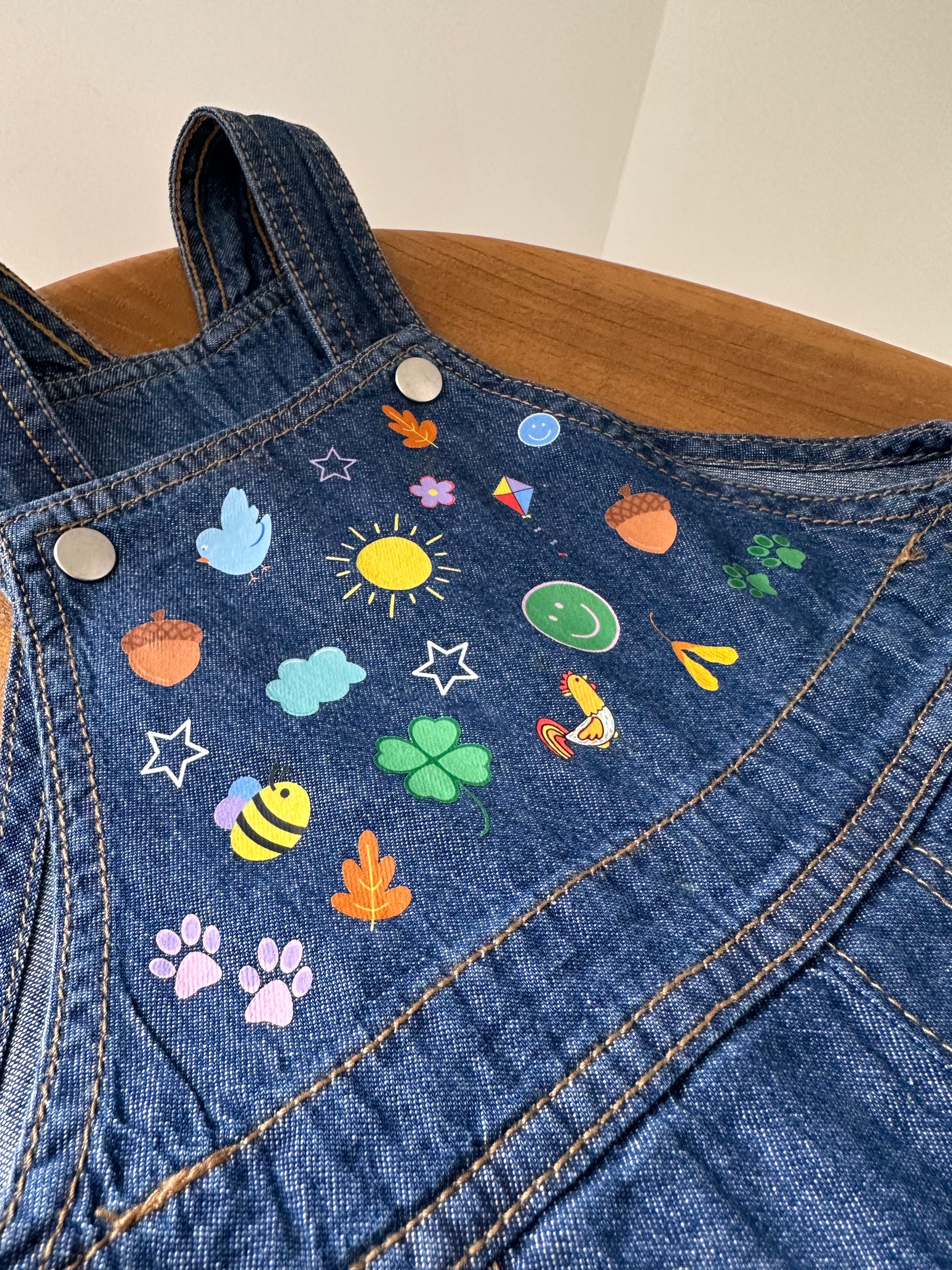 Personalised denim 100% cotton dungarees. Featuring a sunshine, bee's, cockerel, autumn theme. Sustainable toddler denim. 