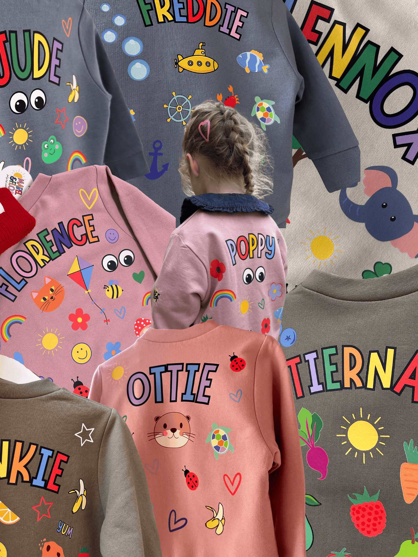 Children wearing sweatshirts with colorful names and designs on a gray background